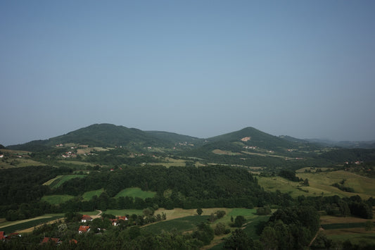A view of a valley with a few hills in the distance
