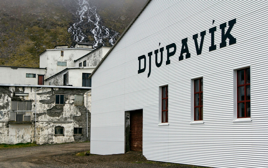 A white building with a sign on the side of it