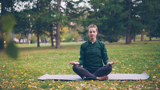 Woman meditating in a peaceful park setting